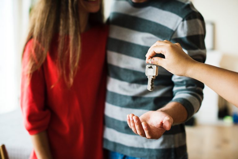 home buyer gets keys from realtor mi